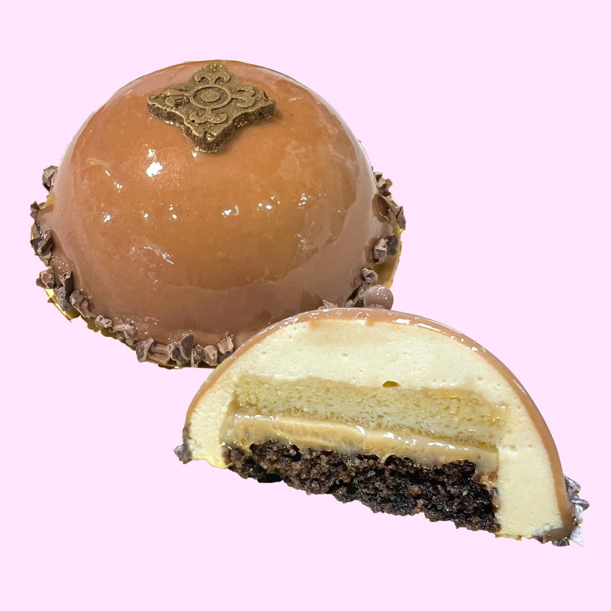 A chocoflan mousse dome cut through to show the layers inside