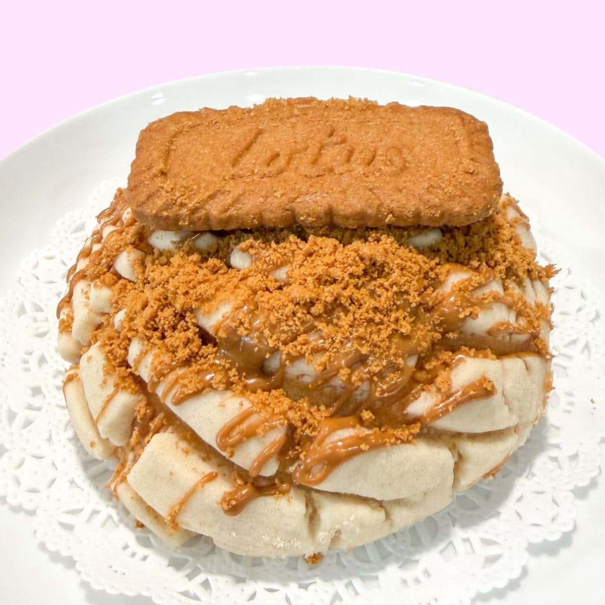 A concha topped with cookie butter and a whole Biscoff cookie