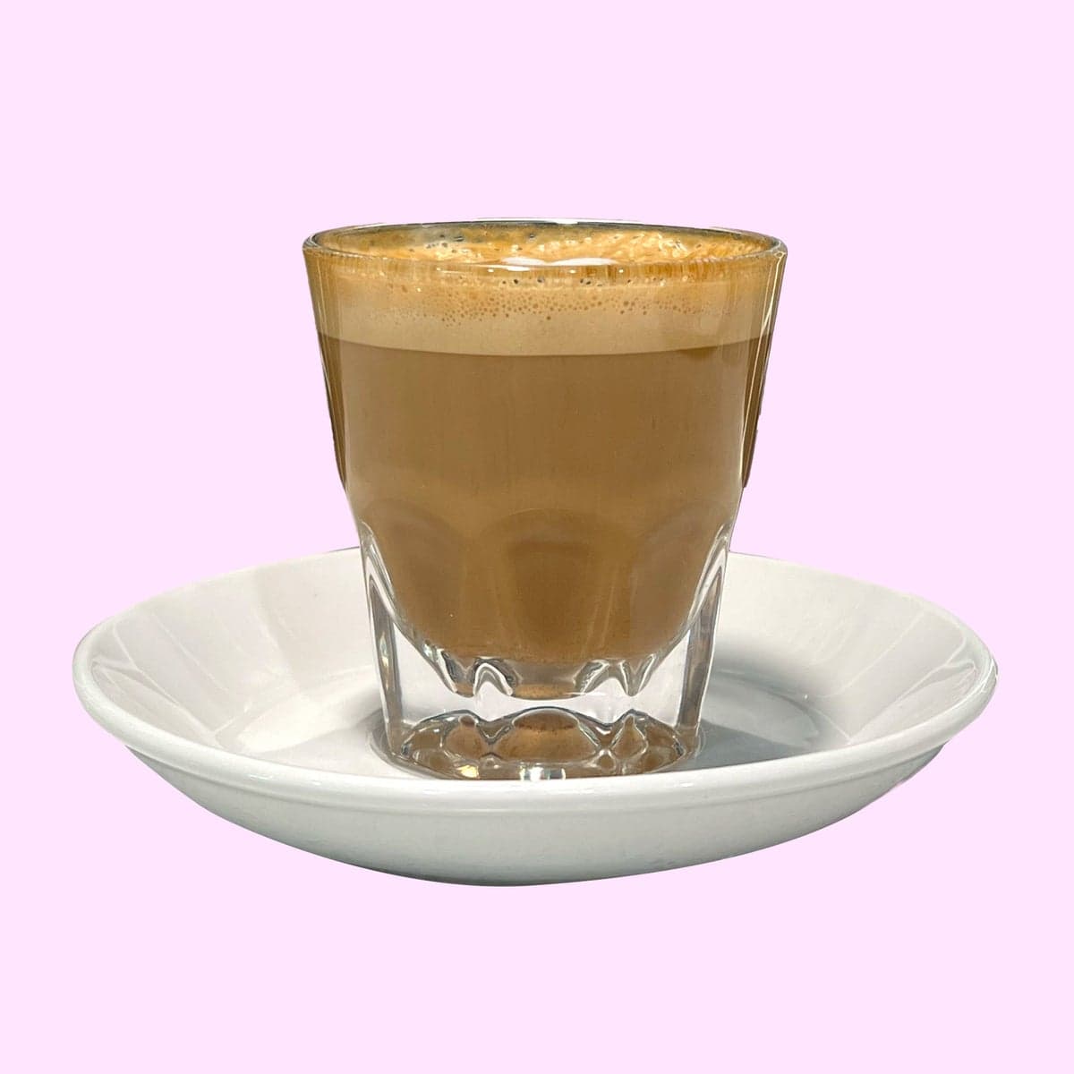 A cortado in a small glass
