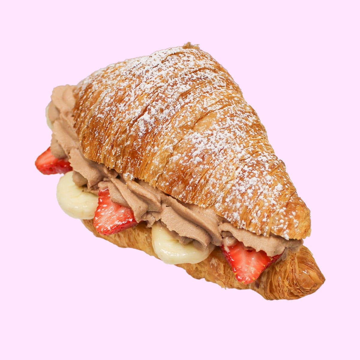 A croissant filled with Nutella cream, strawberries and bananas