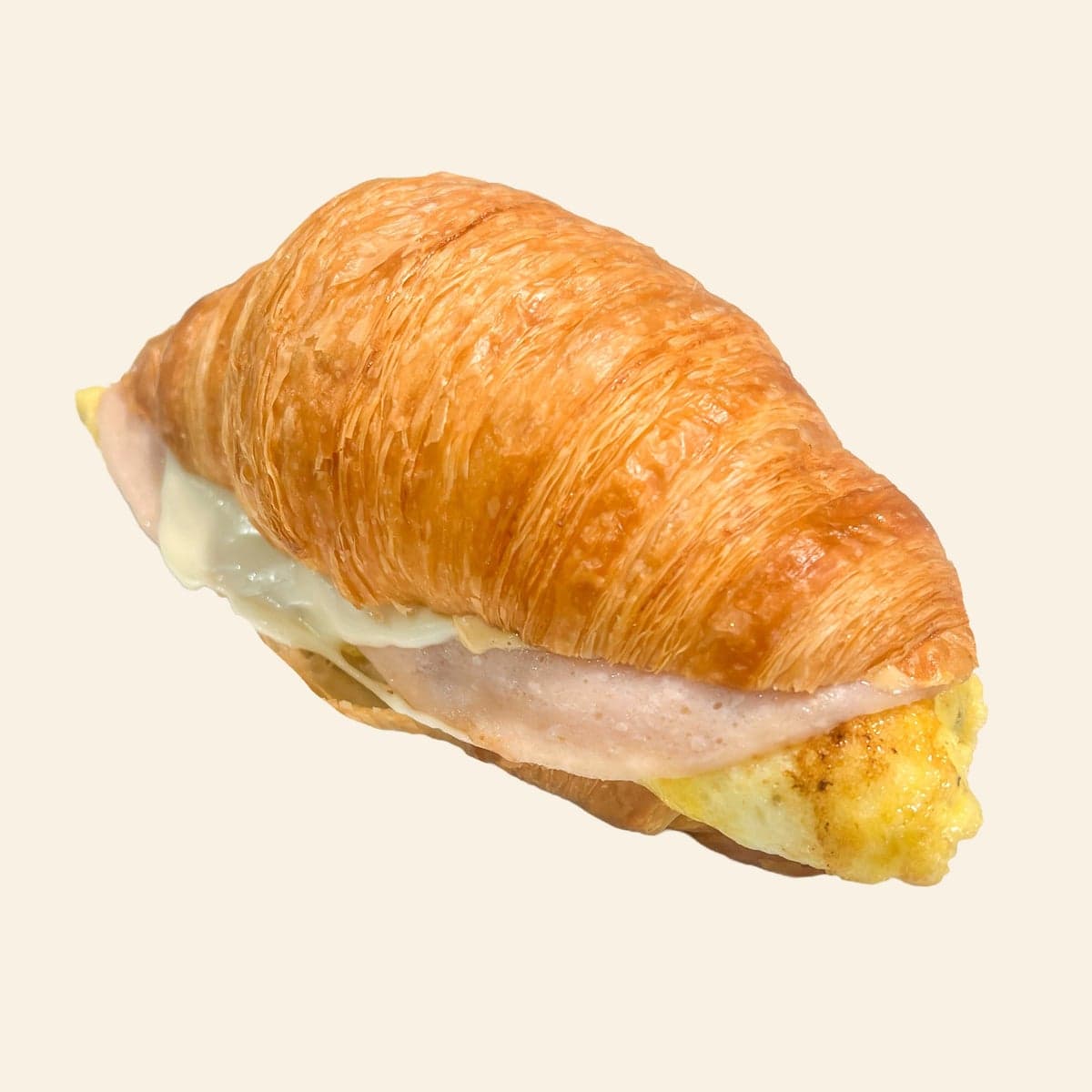 A croissant breakfast sandwich with egg and melted mozzarella