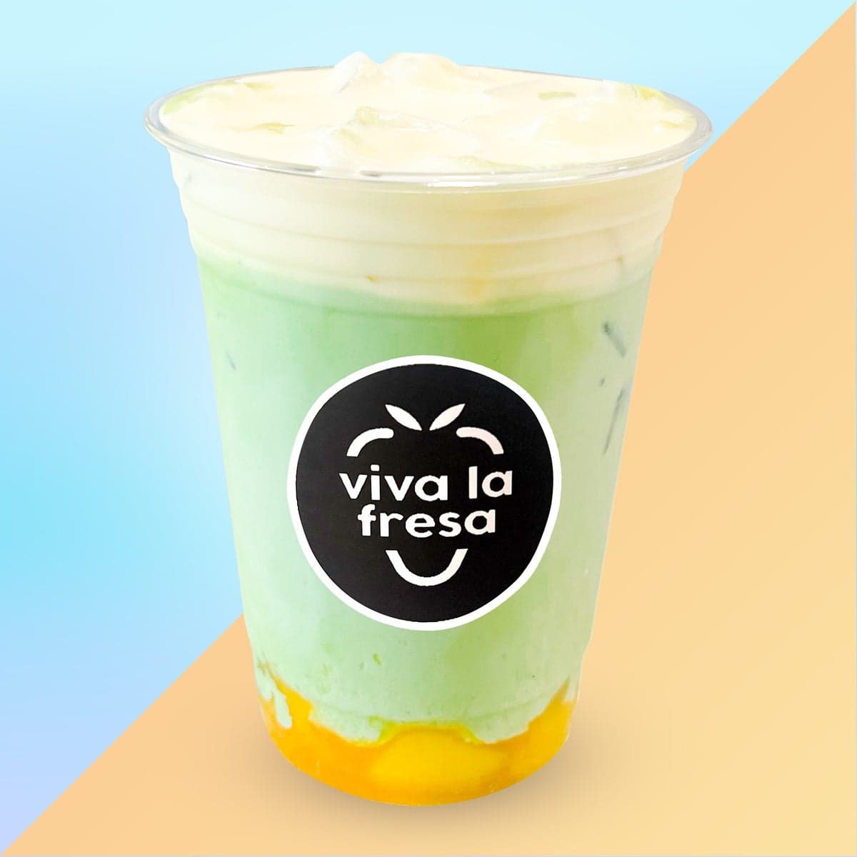 An iced mango matcha latte topped with mango cold foam