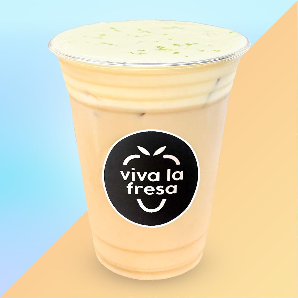 An iced honey and mango latte topped with cold foam and lime zest